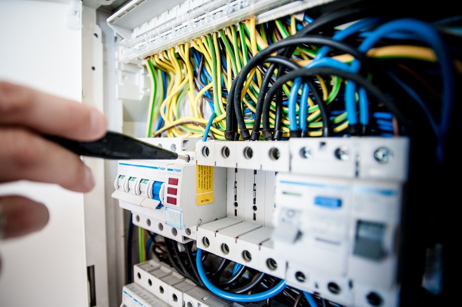 Electrician wiring a circuit breaker panel